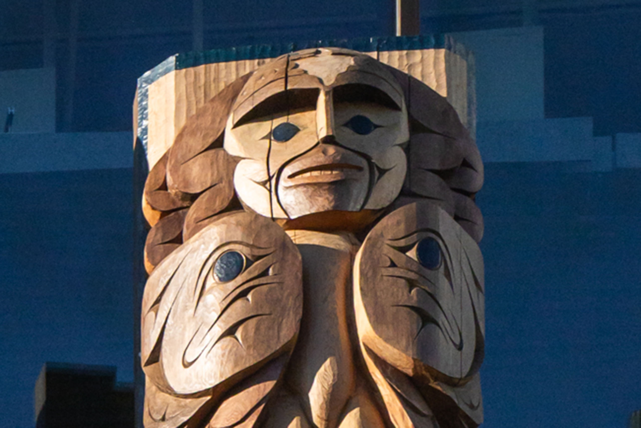 A close-up on a portion of the house post carved by Jonas Jones